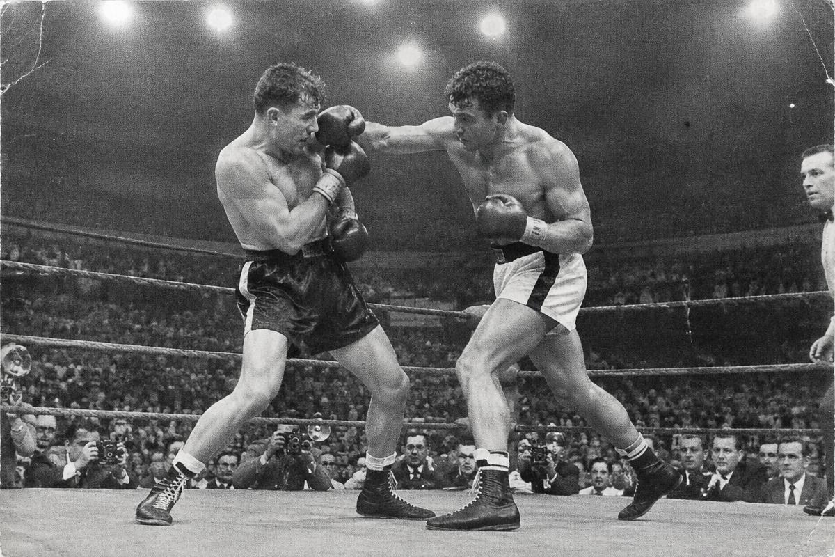 Two boxers trading punches in the ring