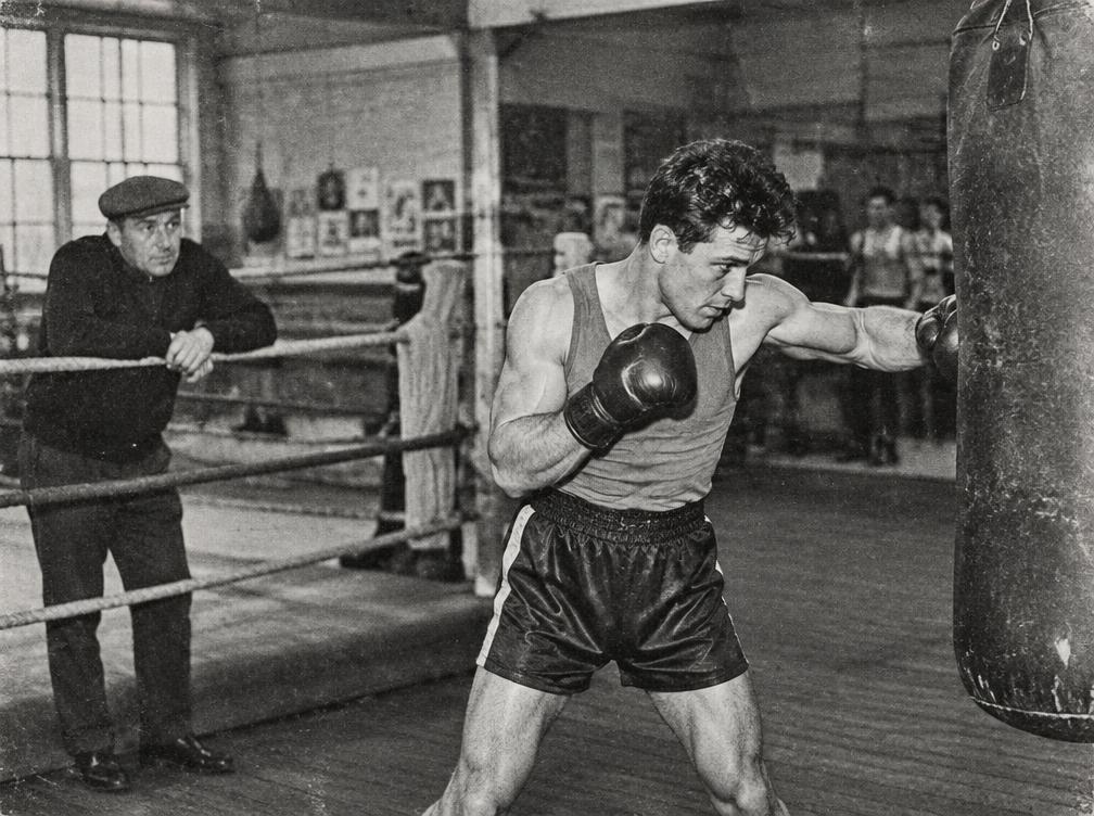 A boxer working the heavy bag during training